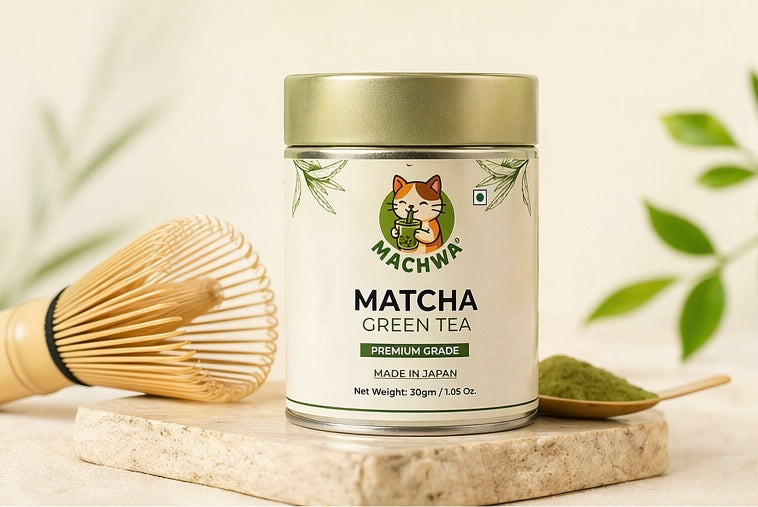 Machwa Matcha Green Tea canister with a wooden whisk and spoonful of matcha powder on a light background